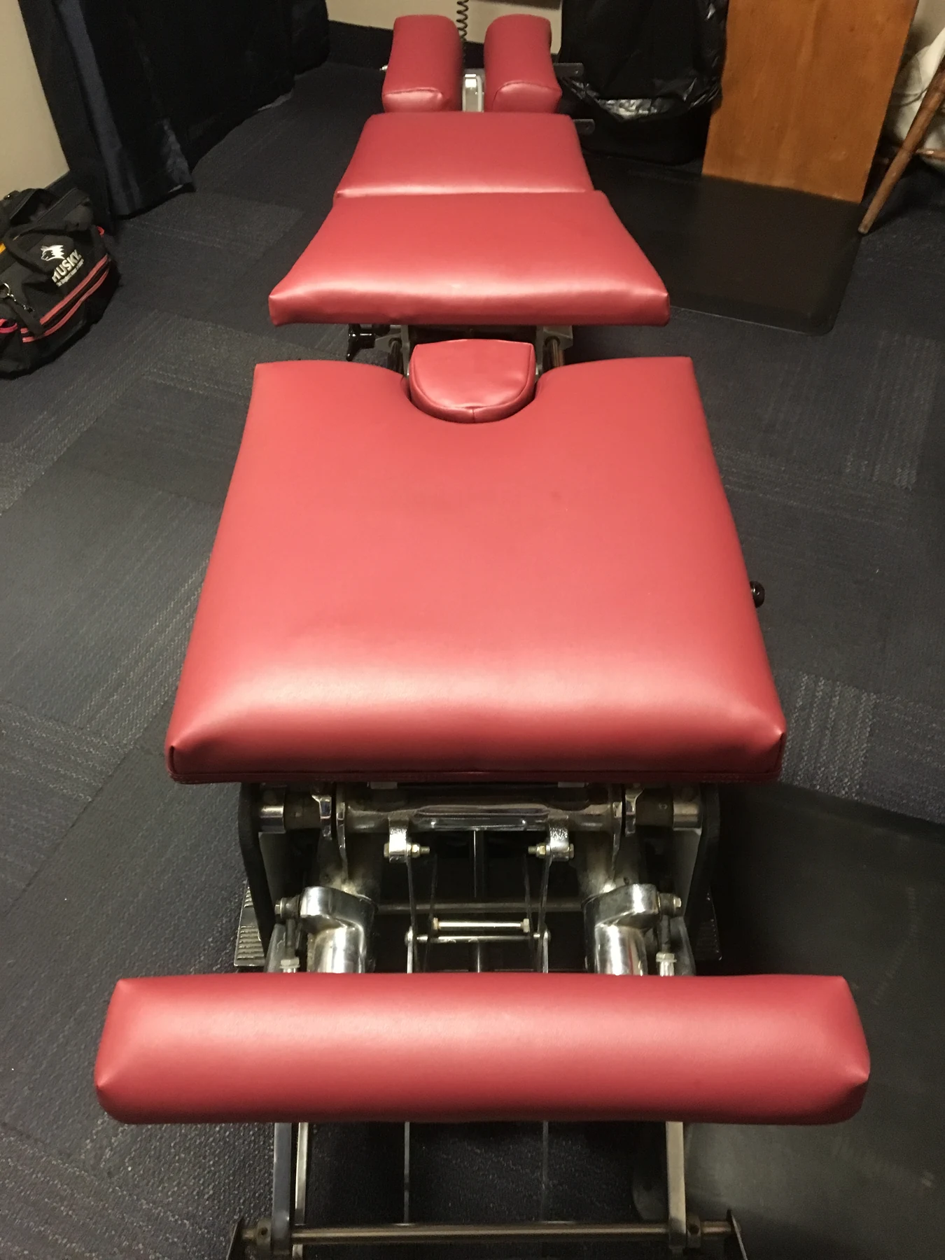 Red chiropractic adjustment table after completed upholstery